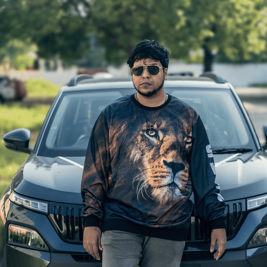 Man wearing a sweater with a tiger design in front of a black SUV.